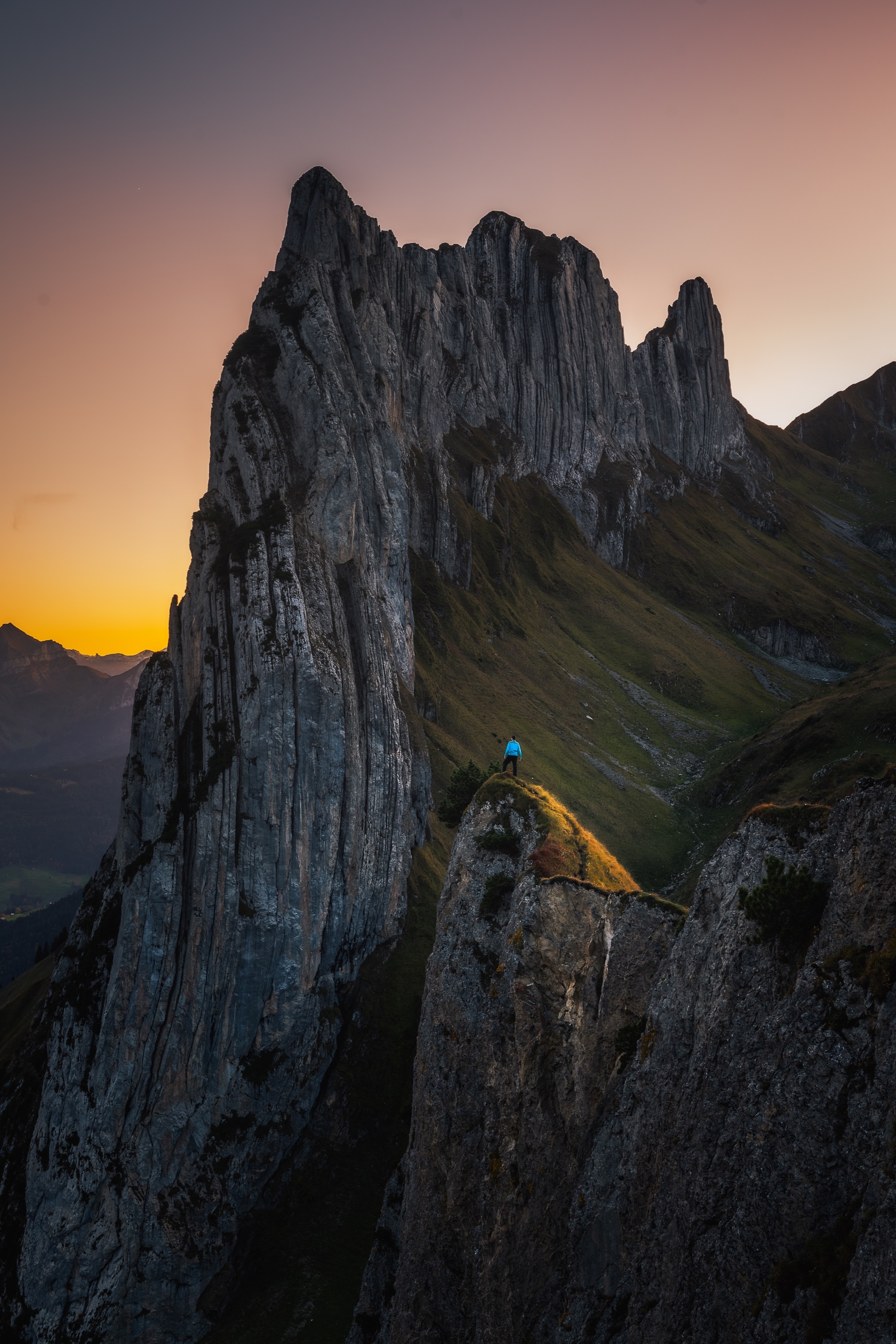 Photographer standing before a mountain while planning a photography trip
