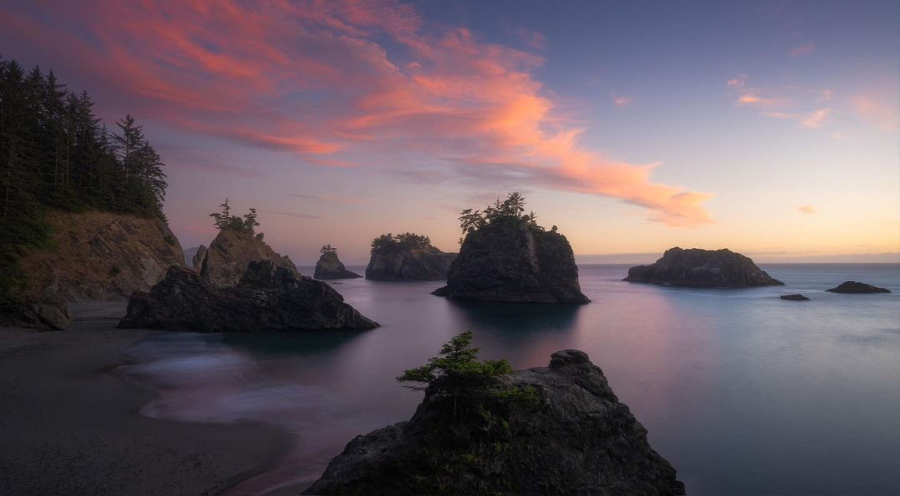 Fiery sunset above sea stacks at an Oregon Coast overlook photographed by student Ryan P.