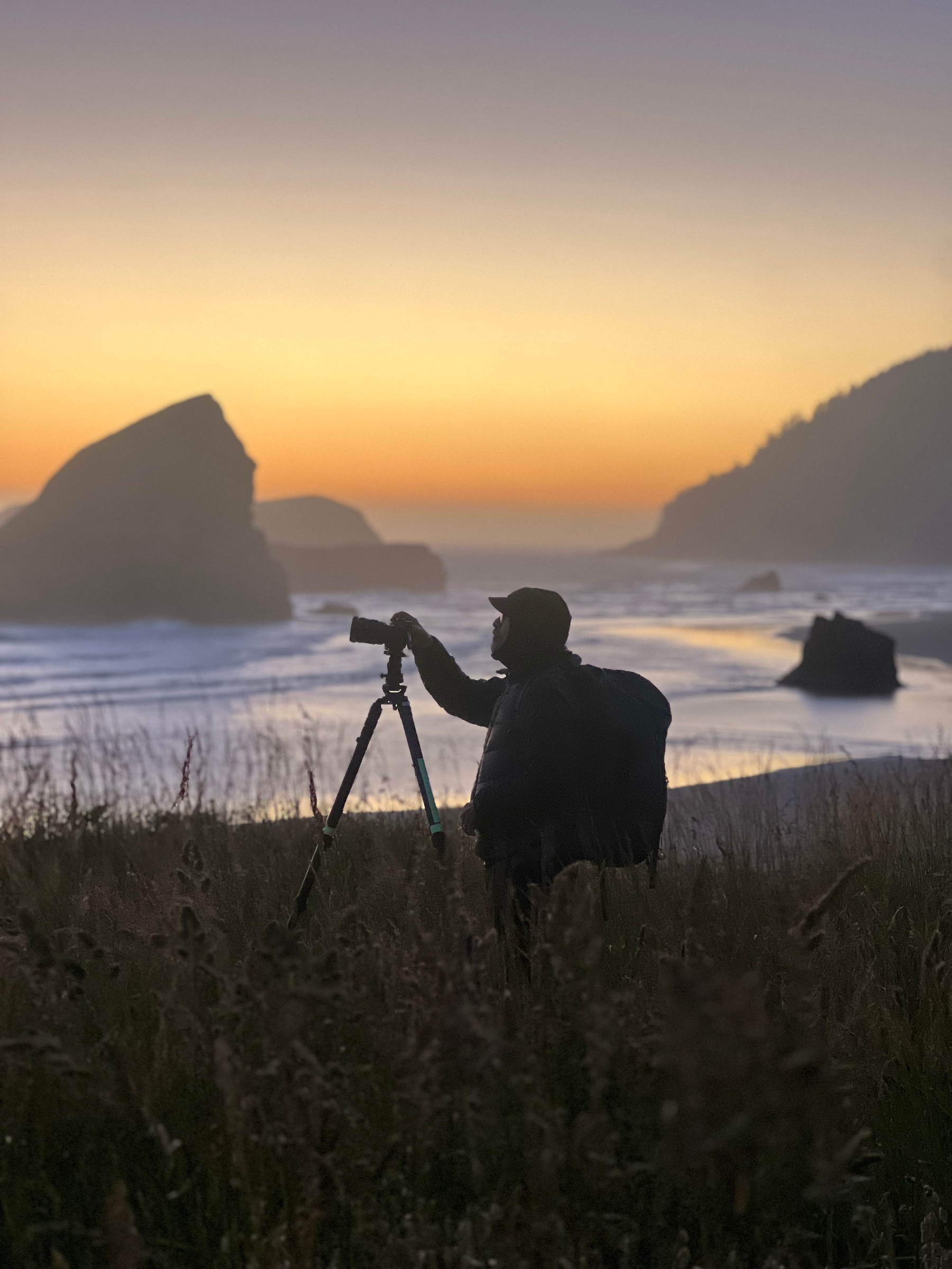 Workshop participant photographing the Oregon Coast at sunset