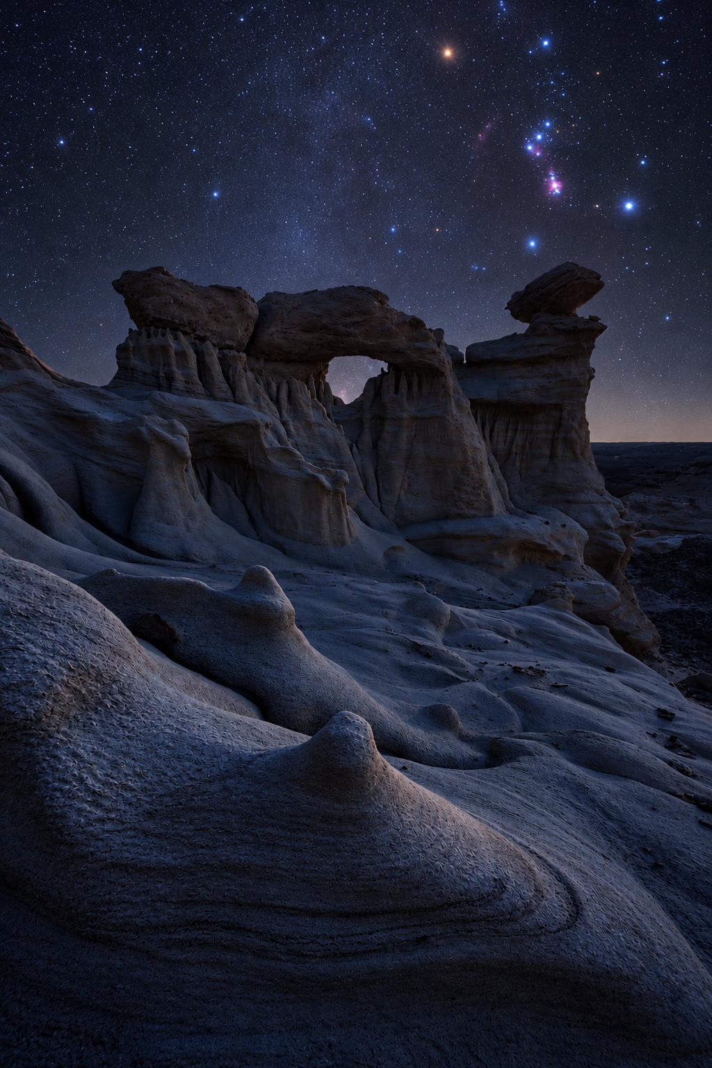 Orion rising above a sandstone arch in the Bisti Badlands