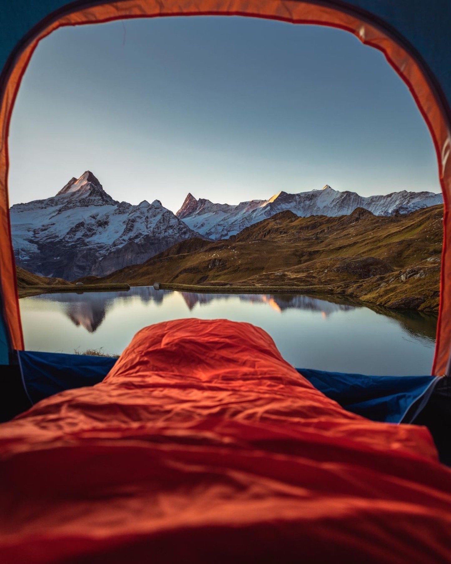 Sleeping bag view mountain lake sunrise open tent camping