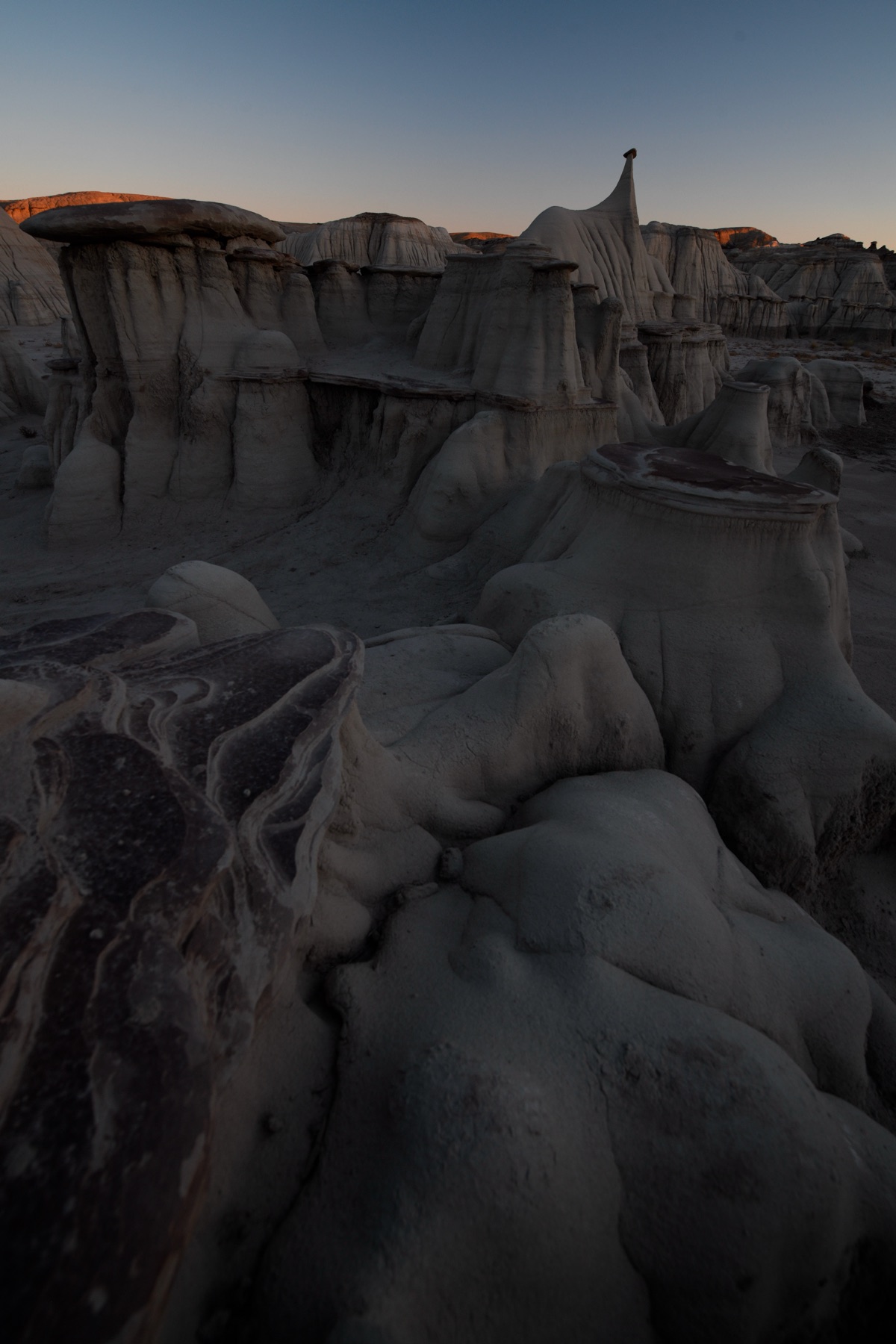 Nikon D850 foreground photograph of hoodoo formations in the Bisti Badlands captured at 14mm.