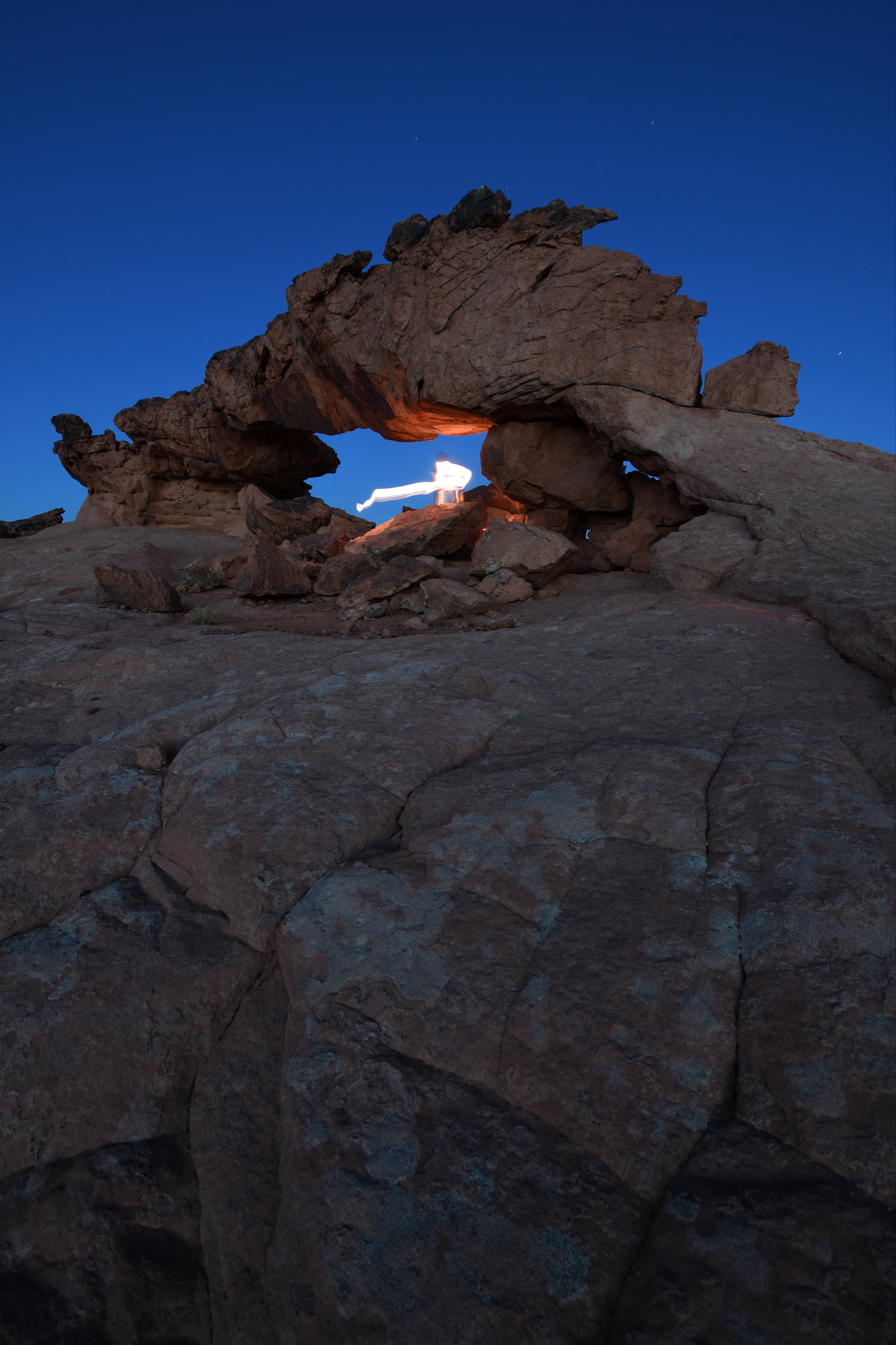 Blue hour Nikon D850 exposure of a Utah sandstone arch used as part of a multi frame light painted foreground blend.