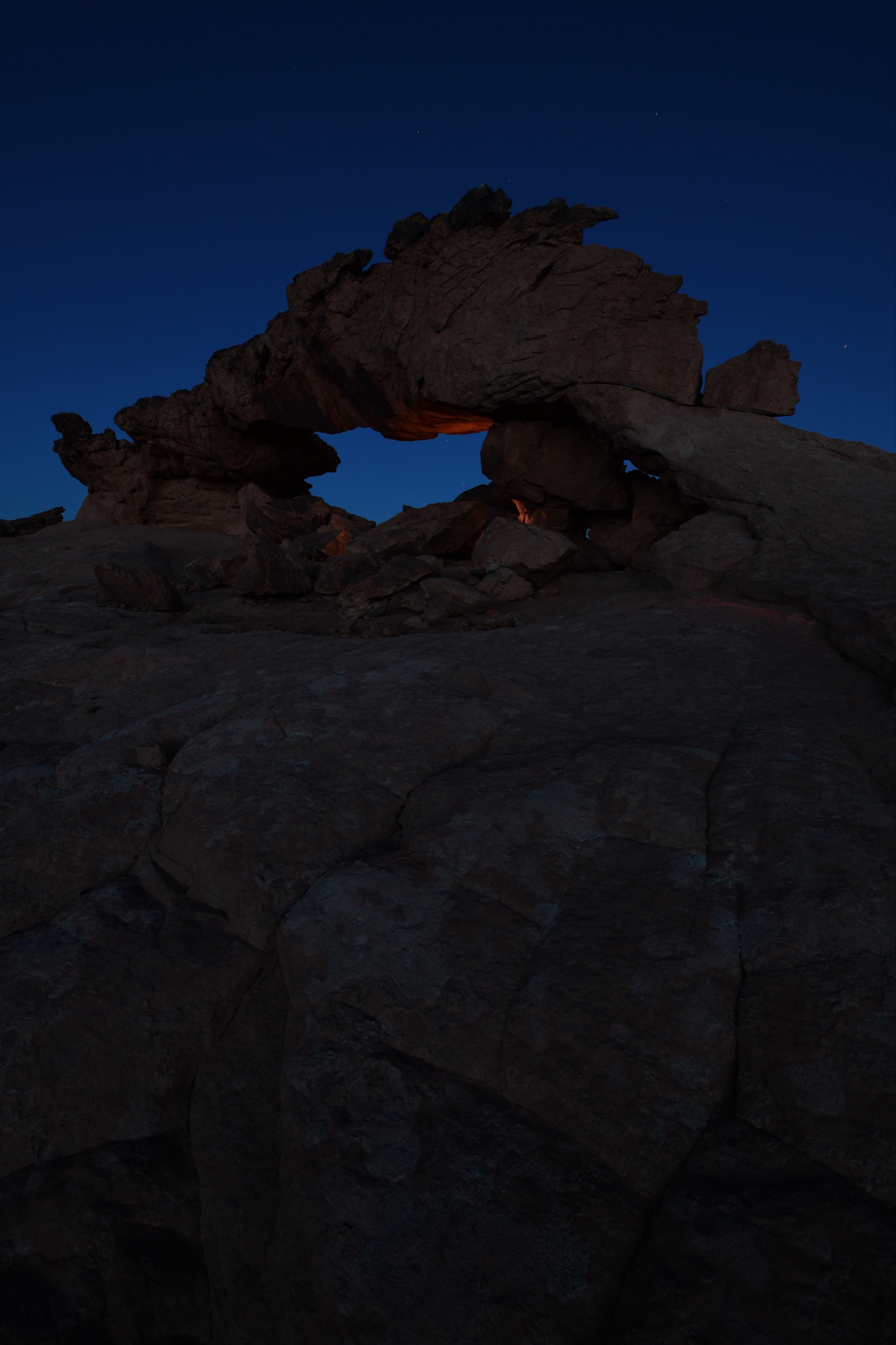Blue hour Nikon D850 exposure of a Utah sandstone arch used as part of a multi frame light painted foreground blend.