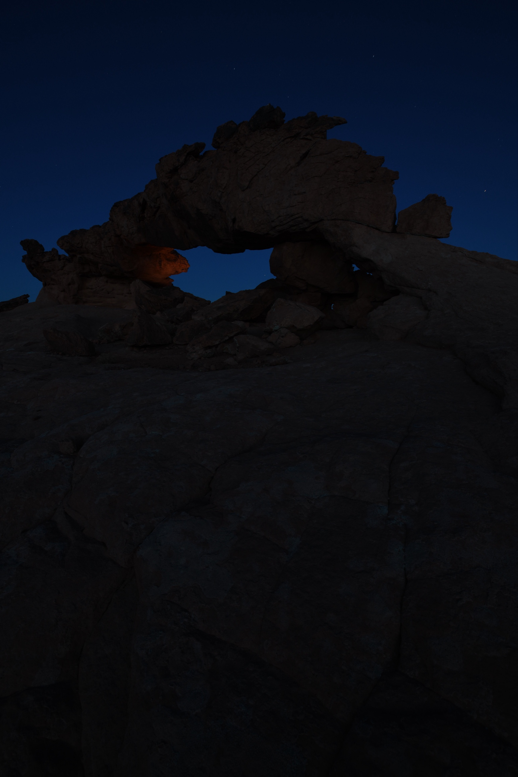 Blue hour Nikon D850 exposure of a Utah sandstone arch used as part of a multi frame light painted foreground blend.