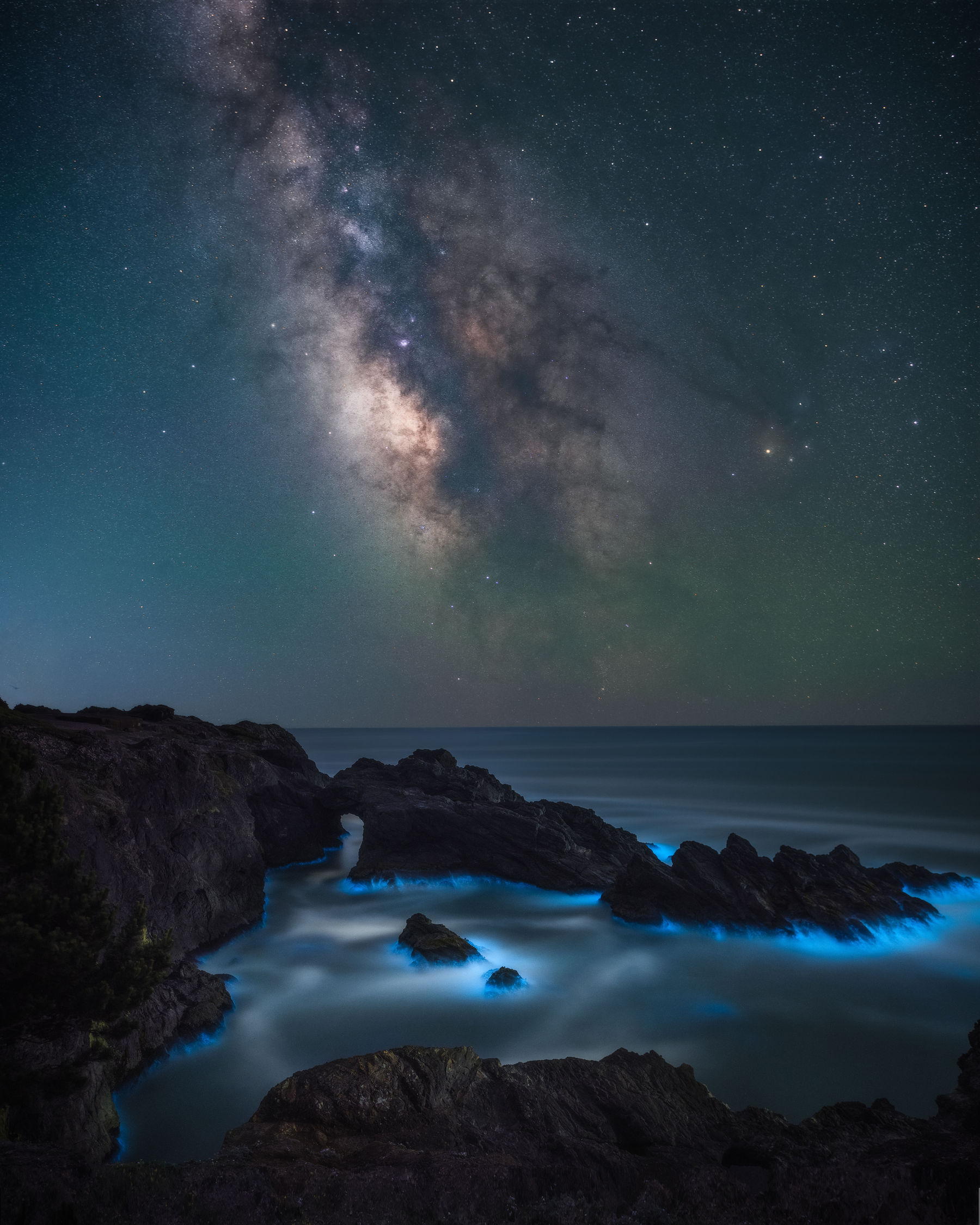 Milky Way, sea stacks and glowing bioluminescent water on the Oregon coast